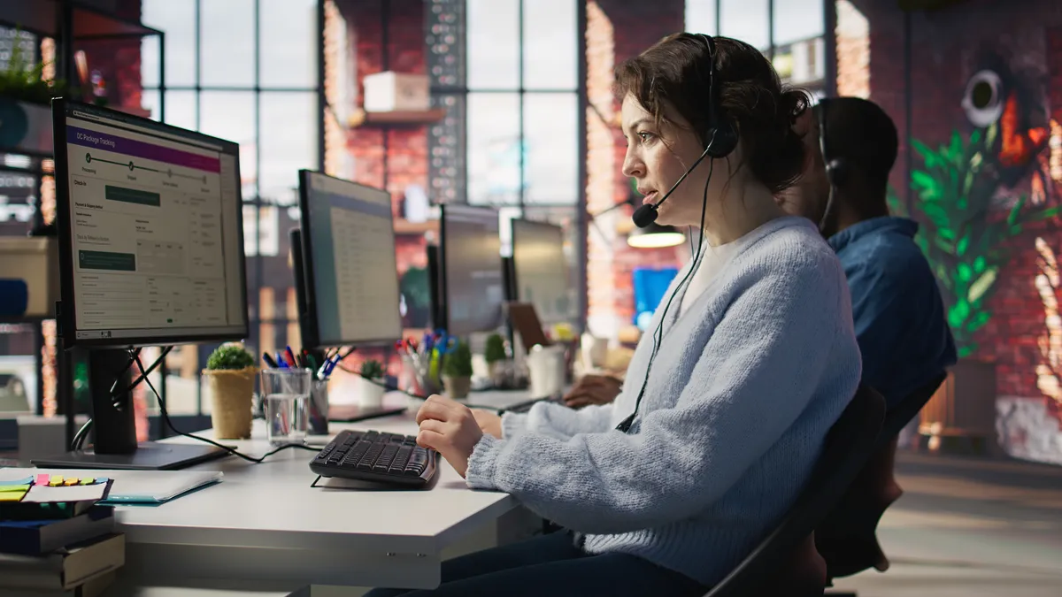 Contact center agents wearing headsets working at desks with support software on screen