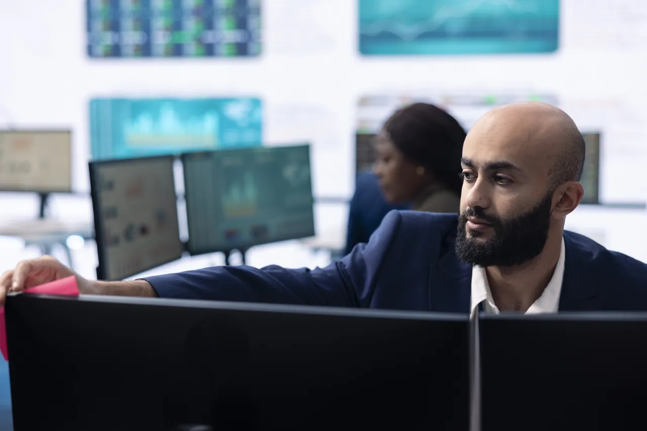QA lead reviewing enterprise test suite dashboards during a UFT migration planning session