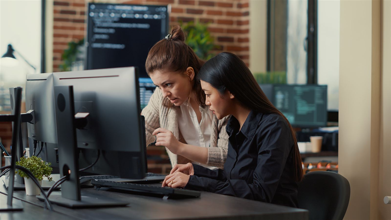 Two engineers comparing code changes while investigating a failed checkout test