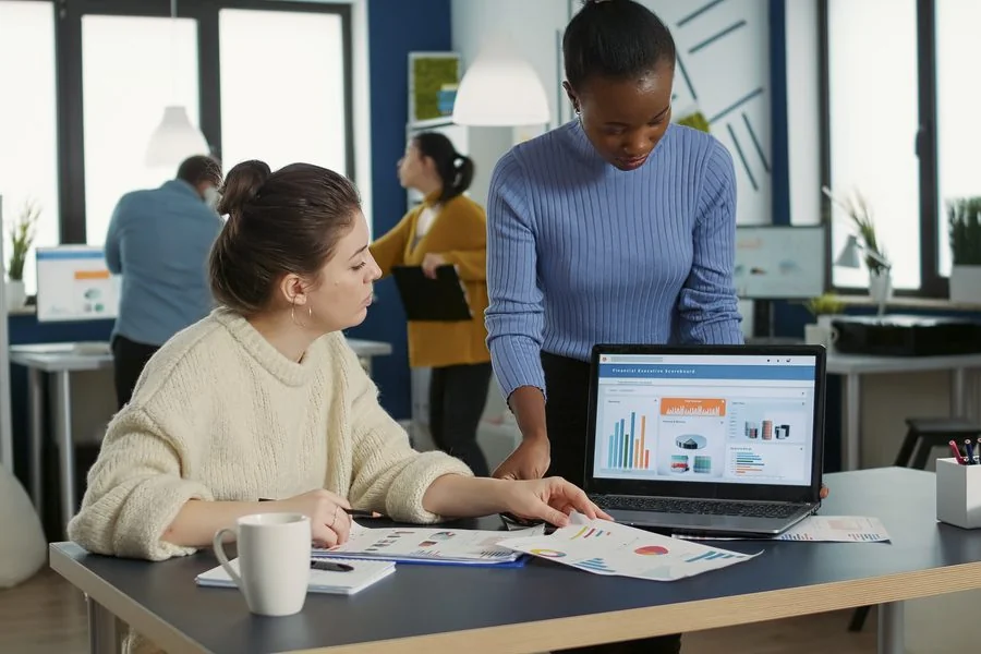 Ecommerce operations team reviewing test and analytics data together on a laptop