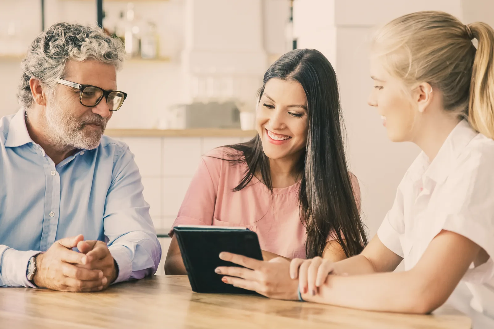 Insurance agent presenting policy and claim details to customers on a tablet